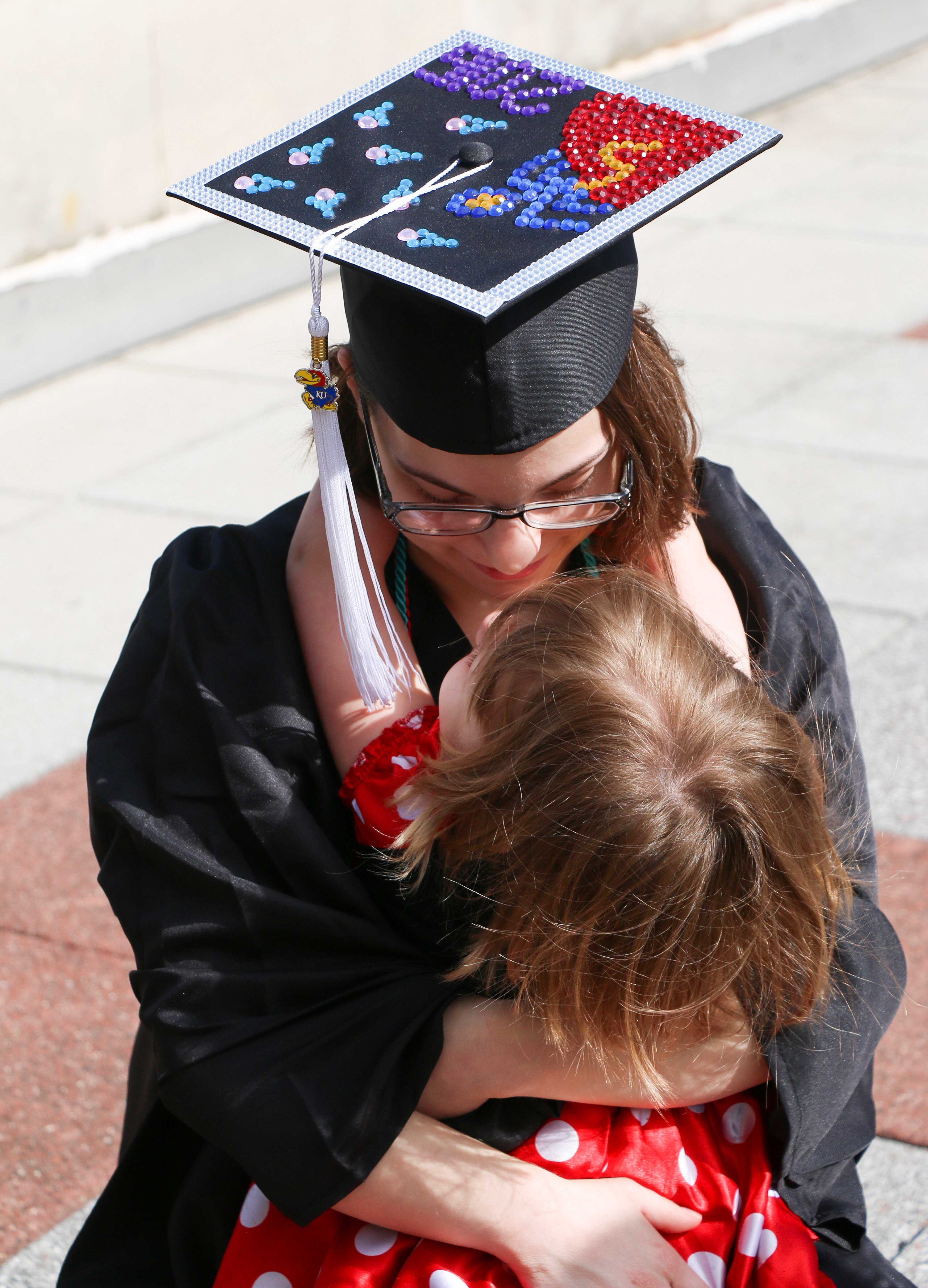 Graduating mother hugging her daughter